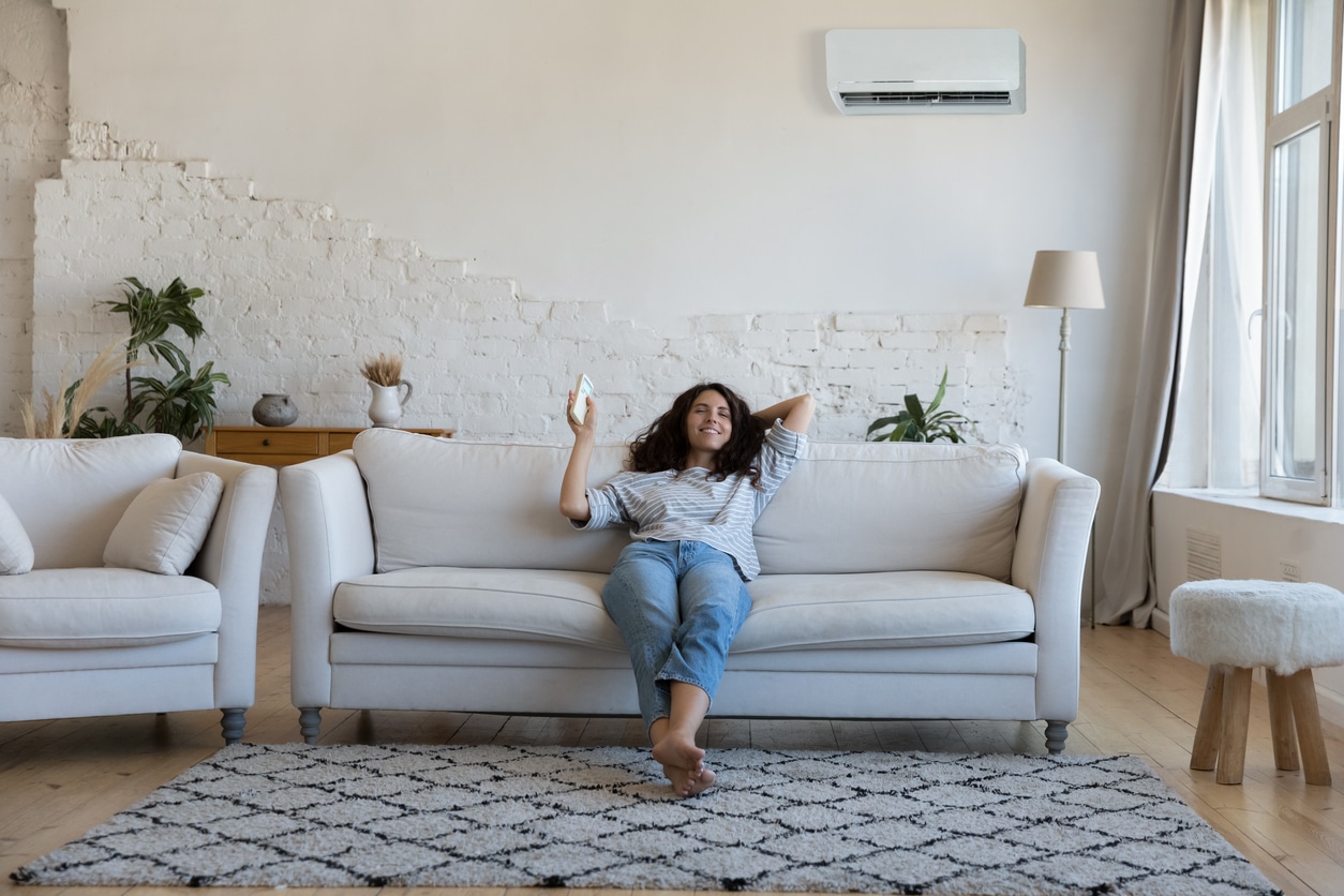 Happy pretty Latin woman enjoying cool conditioned air