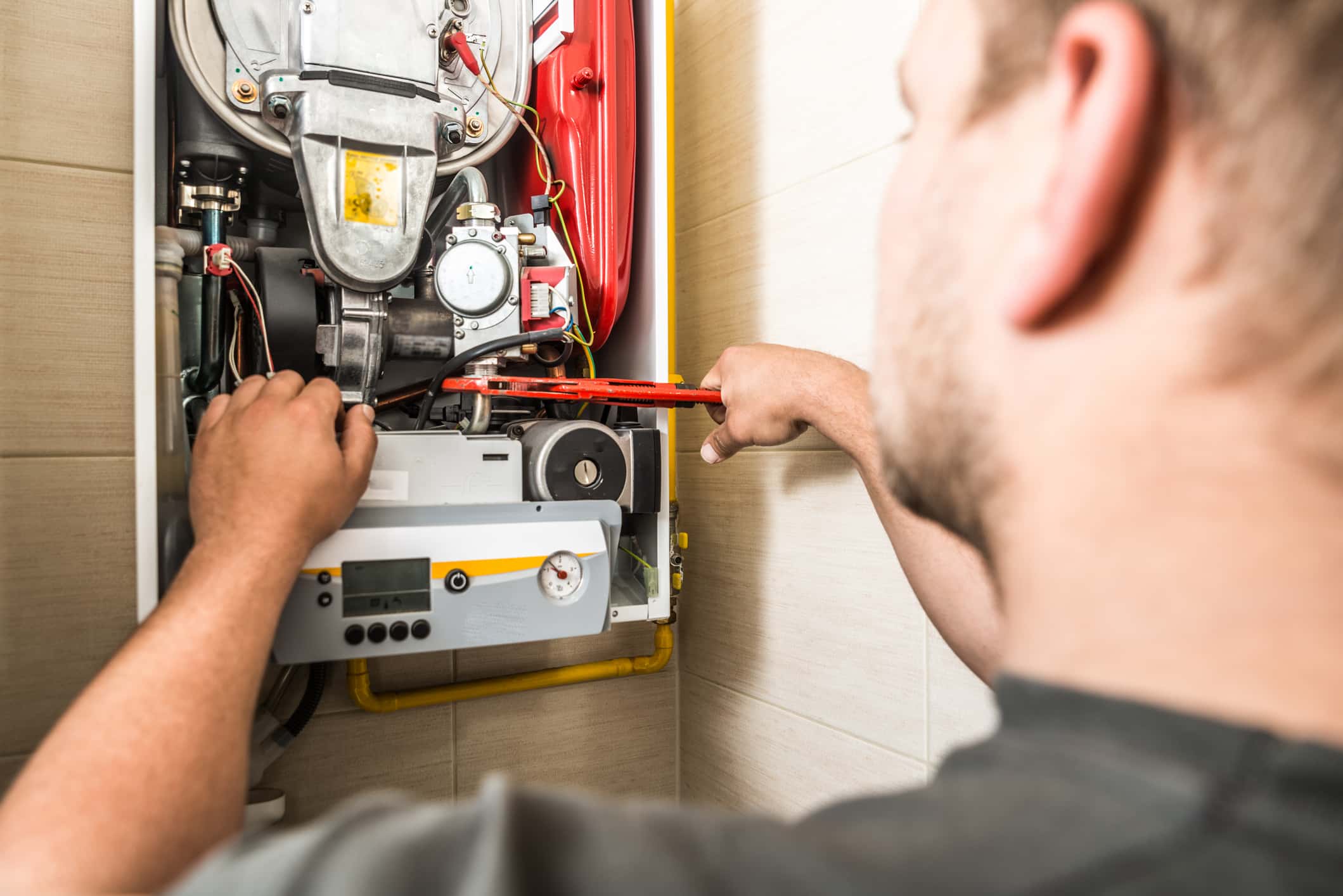 Repairman servicing or repairing furnace